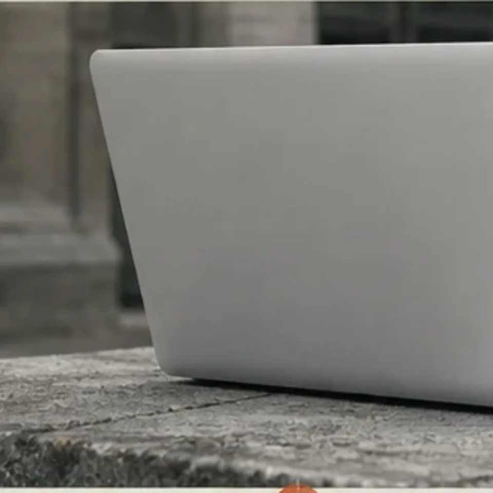 Editorial study of a blank laptop lid used as a digital-event sponsorship surface
